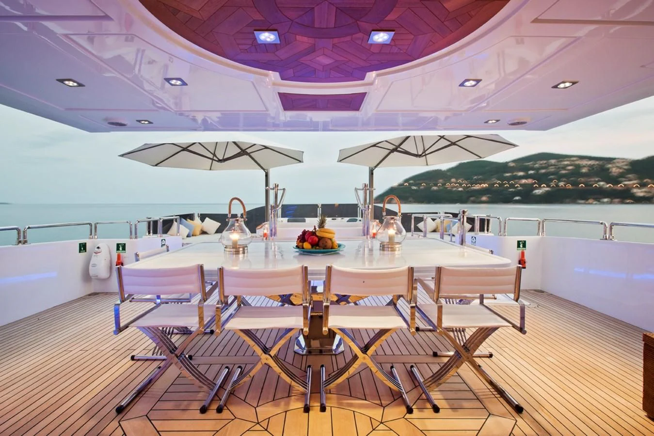 a table with chairs and a pool aboard GRAND CRU Yacht for Sale