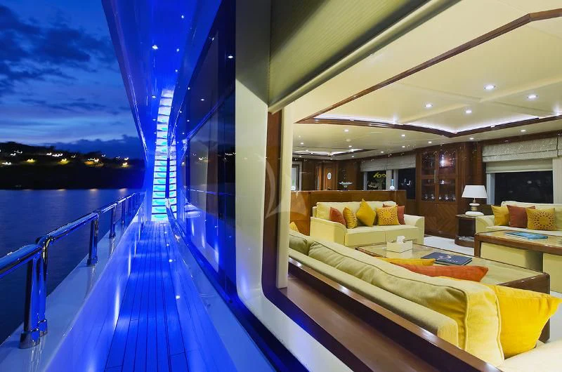 a large room with a large bed and a large blue pool aboard GRAND CRU Yacht for Sale