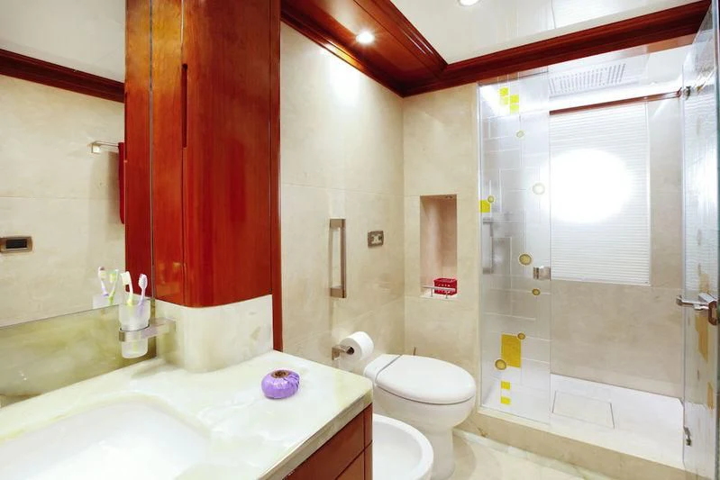 a bathroom with a tub sink and toilet aboard GRAND CRU Yacht for Sale