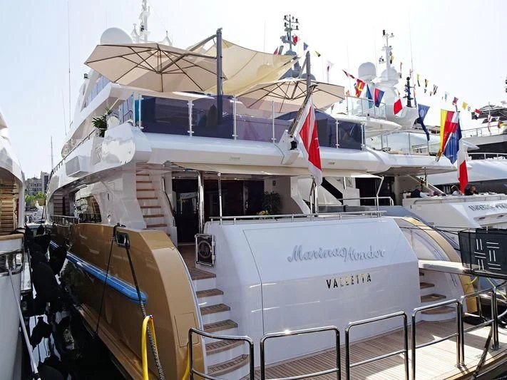 a boat with flags on the deck aboard GRAND CRU Yacht for Sale
