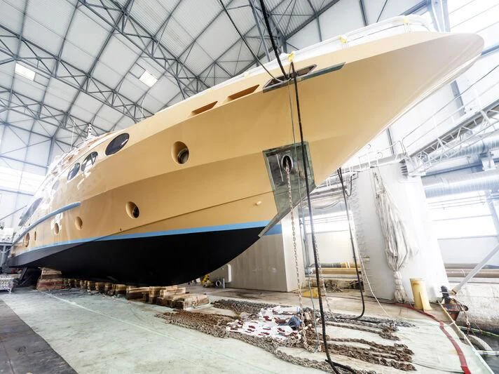 a large metal boat in a warehouse aboard GRAND CRU Yacht for Sale