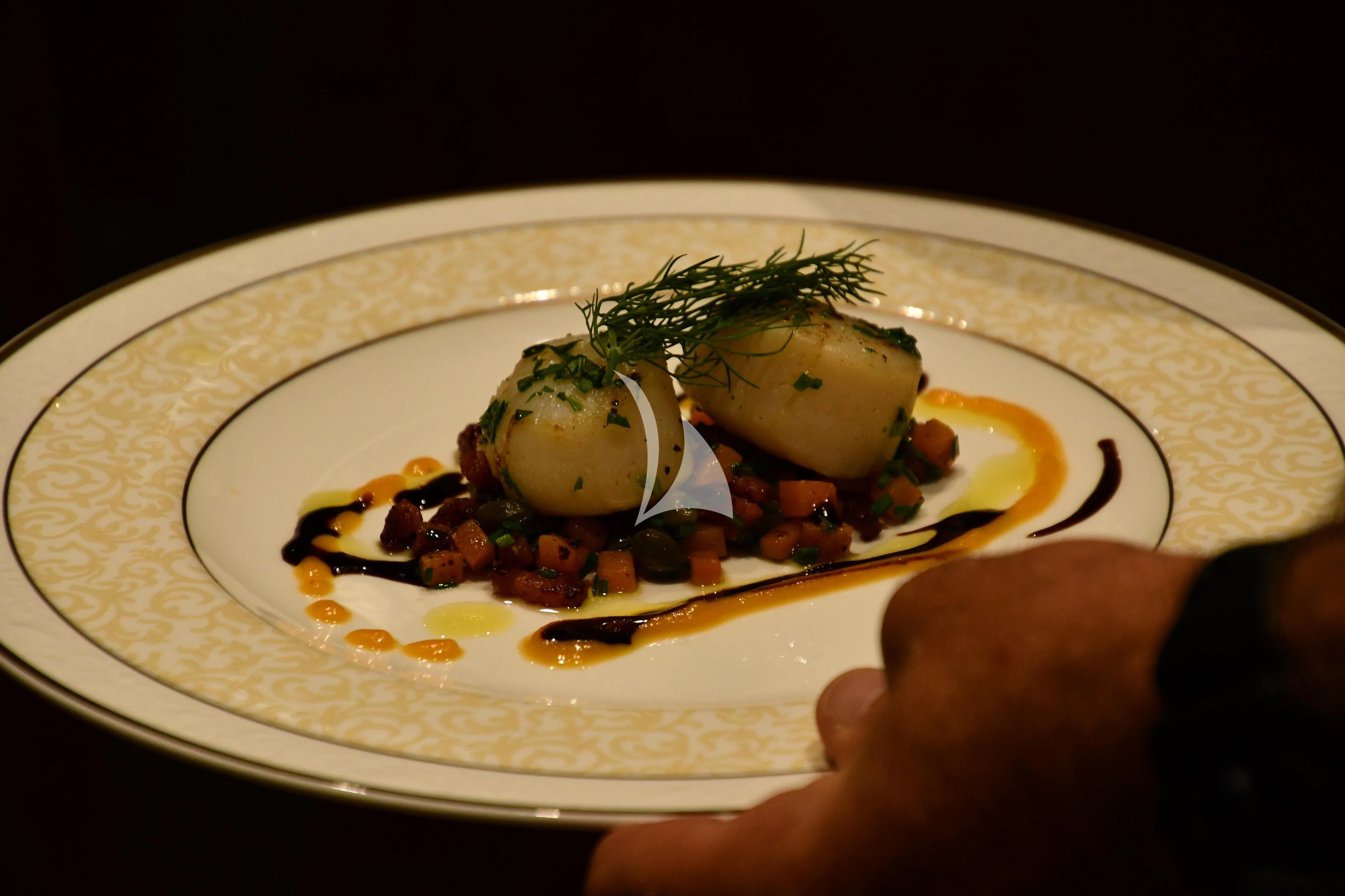 a plate of food aboard GRAND CRU Yacht for Sale