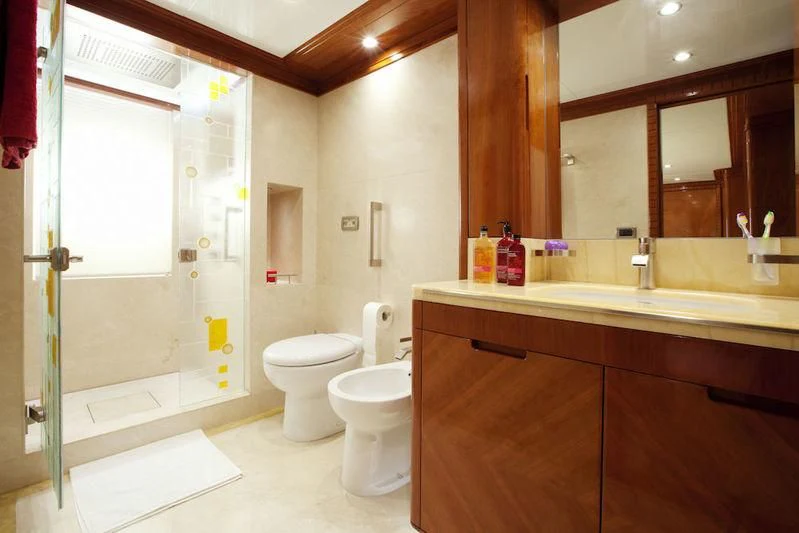 a bathroom with a toilet and a bathtub aboard GRAND CRU Yacht for Sale