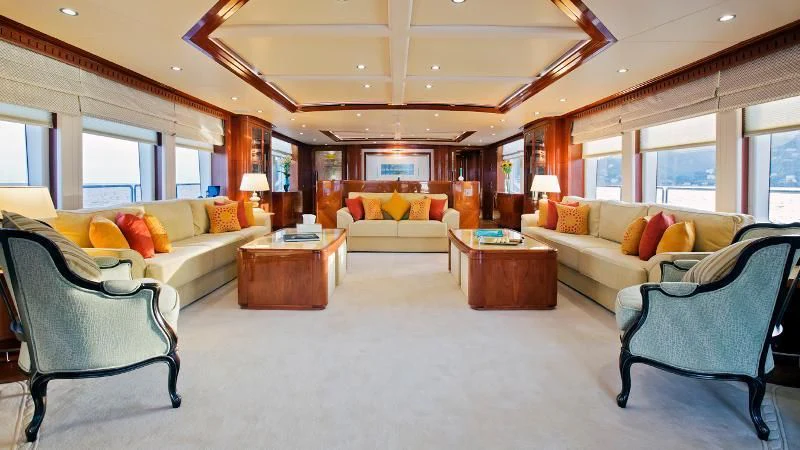 a living room with a couch and a coffee table aboard GRAND CRU Yacht for Sale