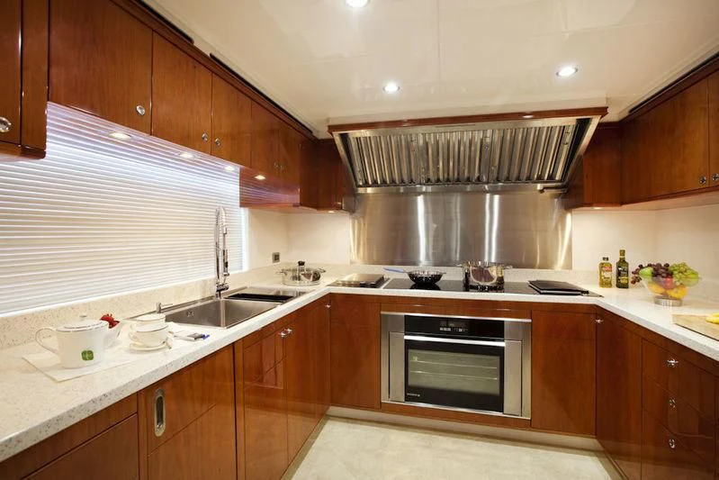 a kitchen with wooden cabinets aboard GRAND CRU Yacht for Sale