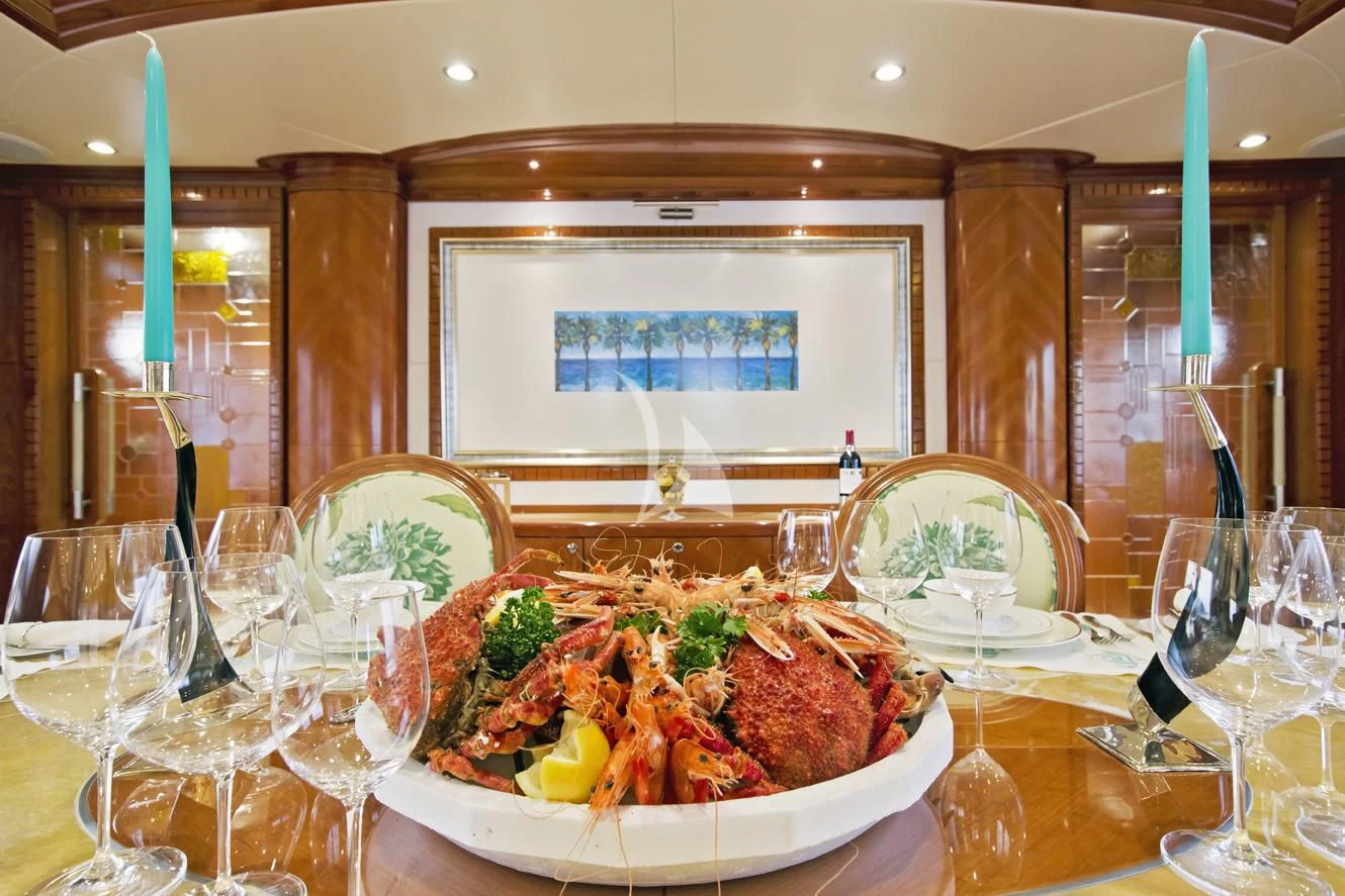 a table with food and wine glasses aboard GRAND CRU Yacht for Sale