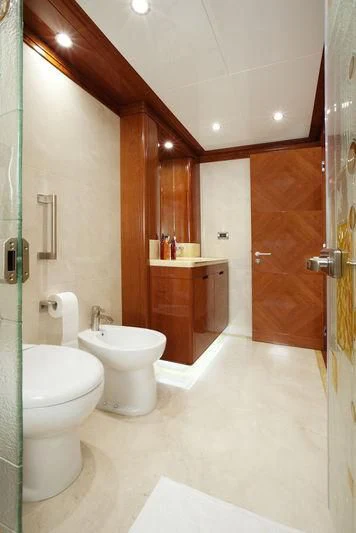 a bathroom with a toilet and a sink aboard GRAND CRU Yacht for Sale