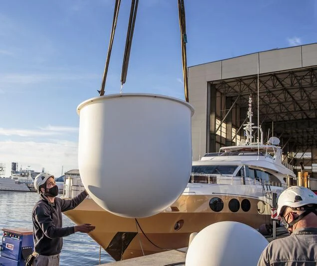 a couple of men looking at a large white ship aboard GRAND CRU Yacht for Sale