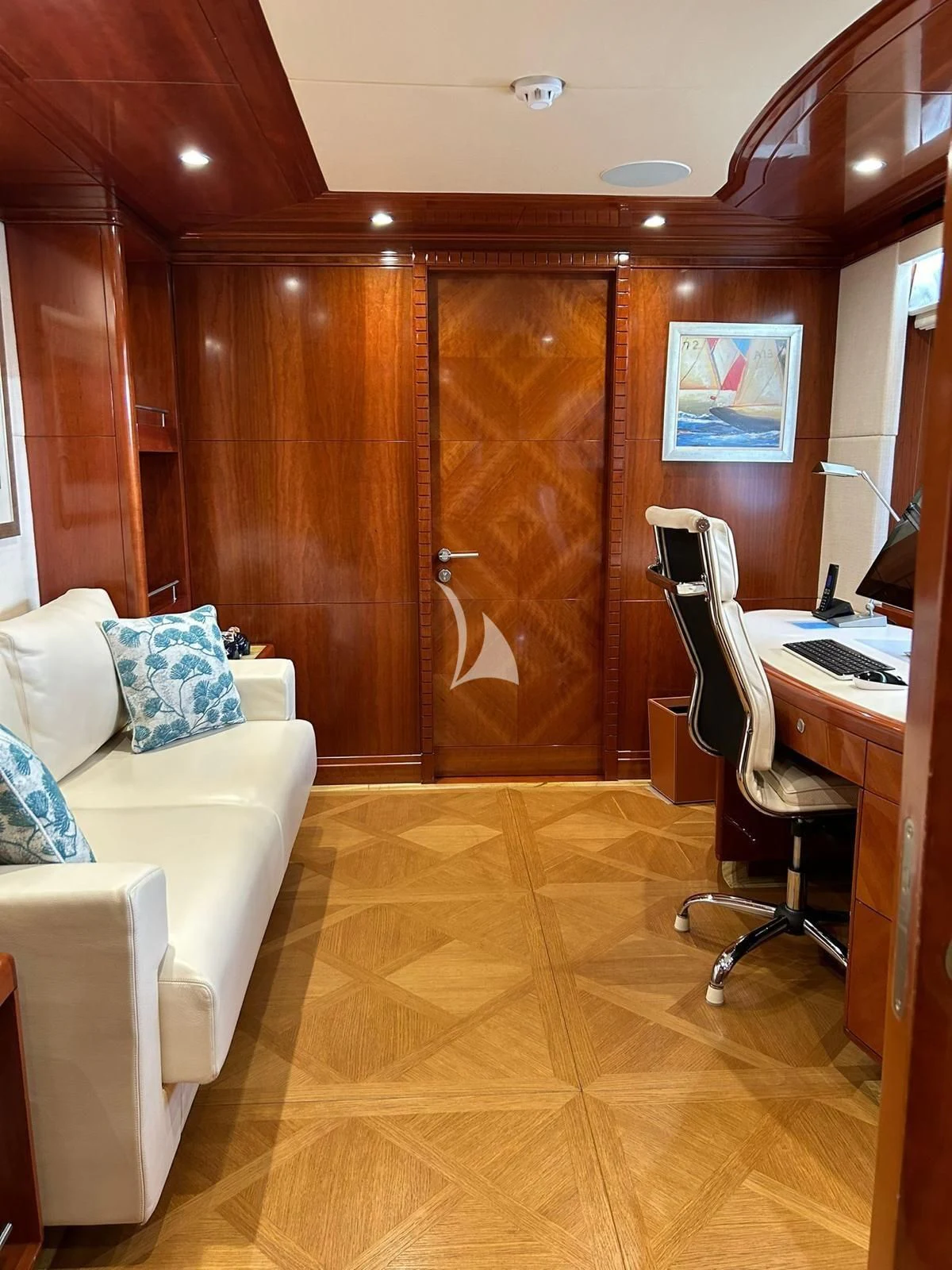 a room with a bed and desk aboard GRAND CRU Yacht for Sale