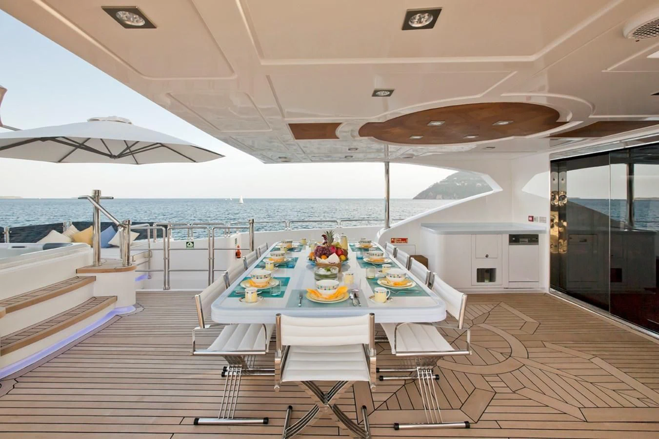 a large lounge area with a table and chairs on it aboard GRAND CRU Yacht for Sale