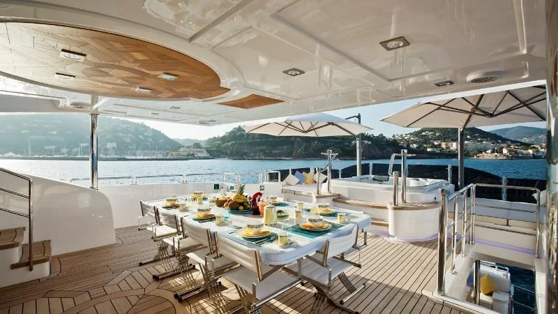 a room with tables and chairs aboard GRAND CRU Yacht for Sale