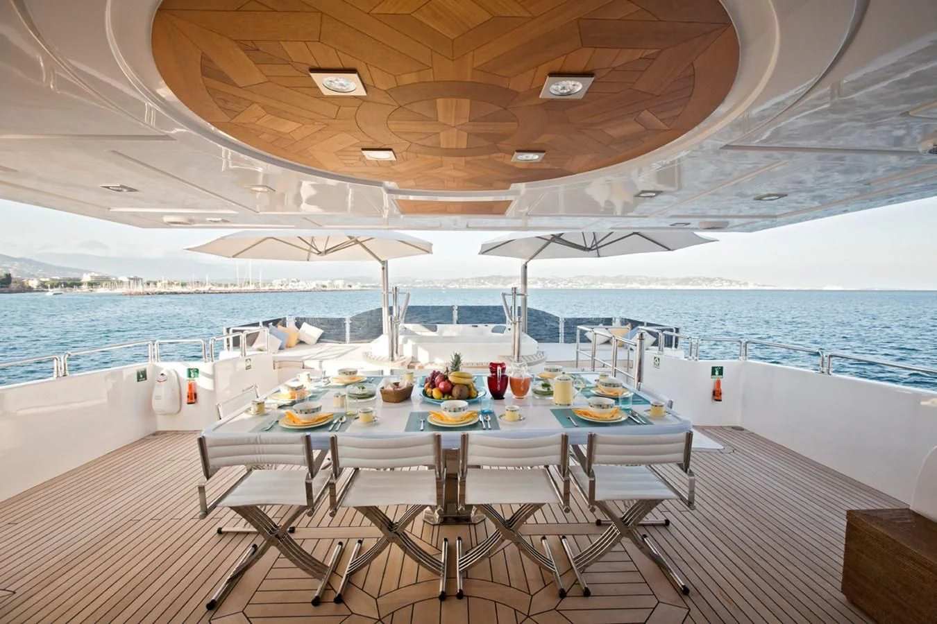 a table and chairs on a deck aboard GRAND CRU Yacht for Sale