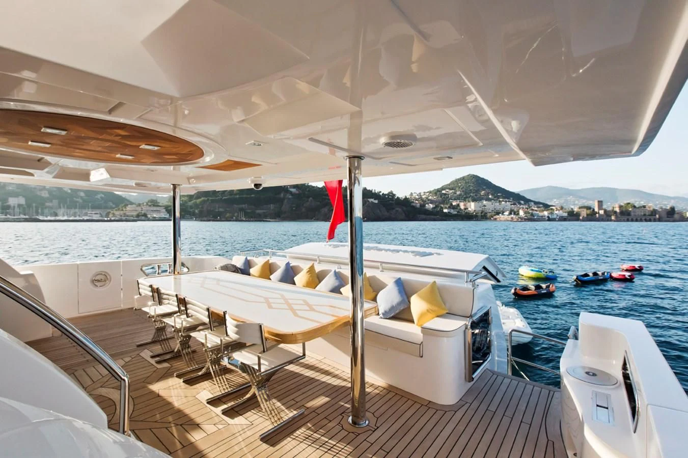 a lounge chair on a deck overlooking a body of water aboard GRAND CRU Yacht for Sale