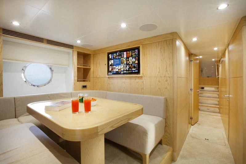 a room with a table and chairs aboard GRAND CRU Yacht for Sale