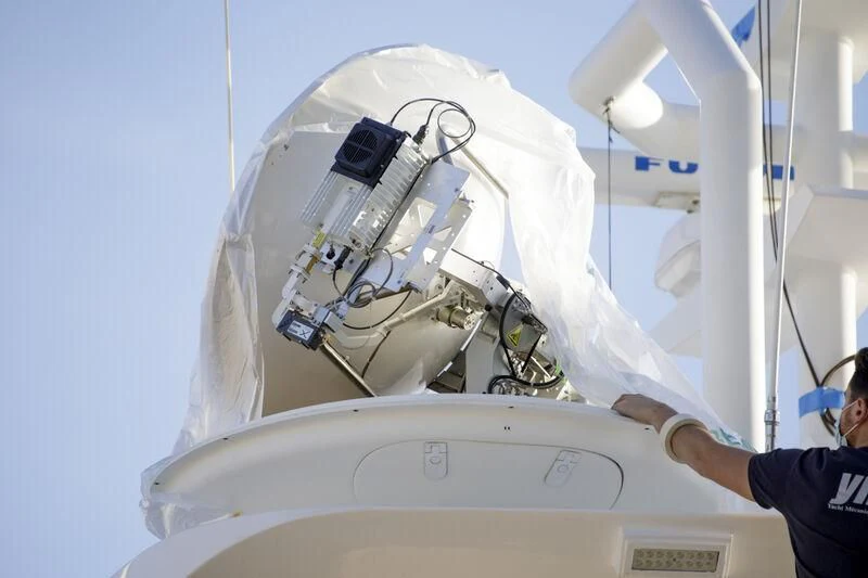 a man wearing a white helmet aboard GRAND CRU Yacht for Sale