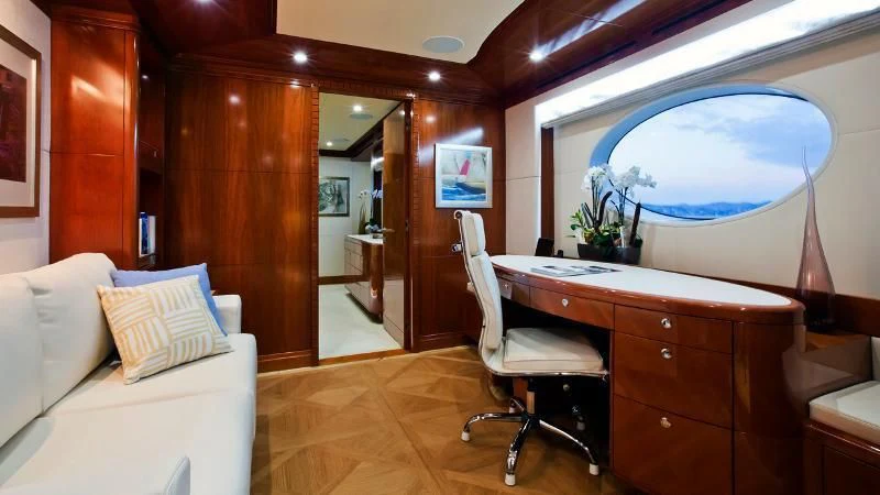 a room with a desk and a bed aboard GRAND CRU Yacht for Sale