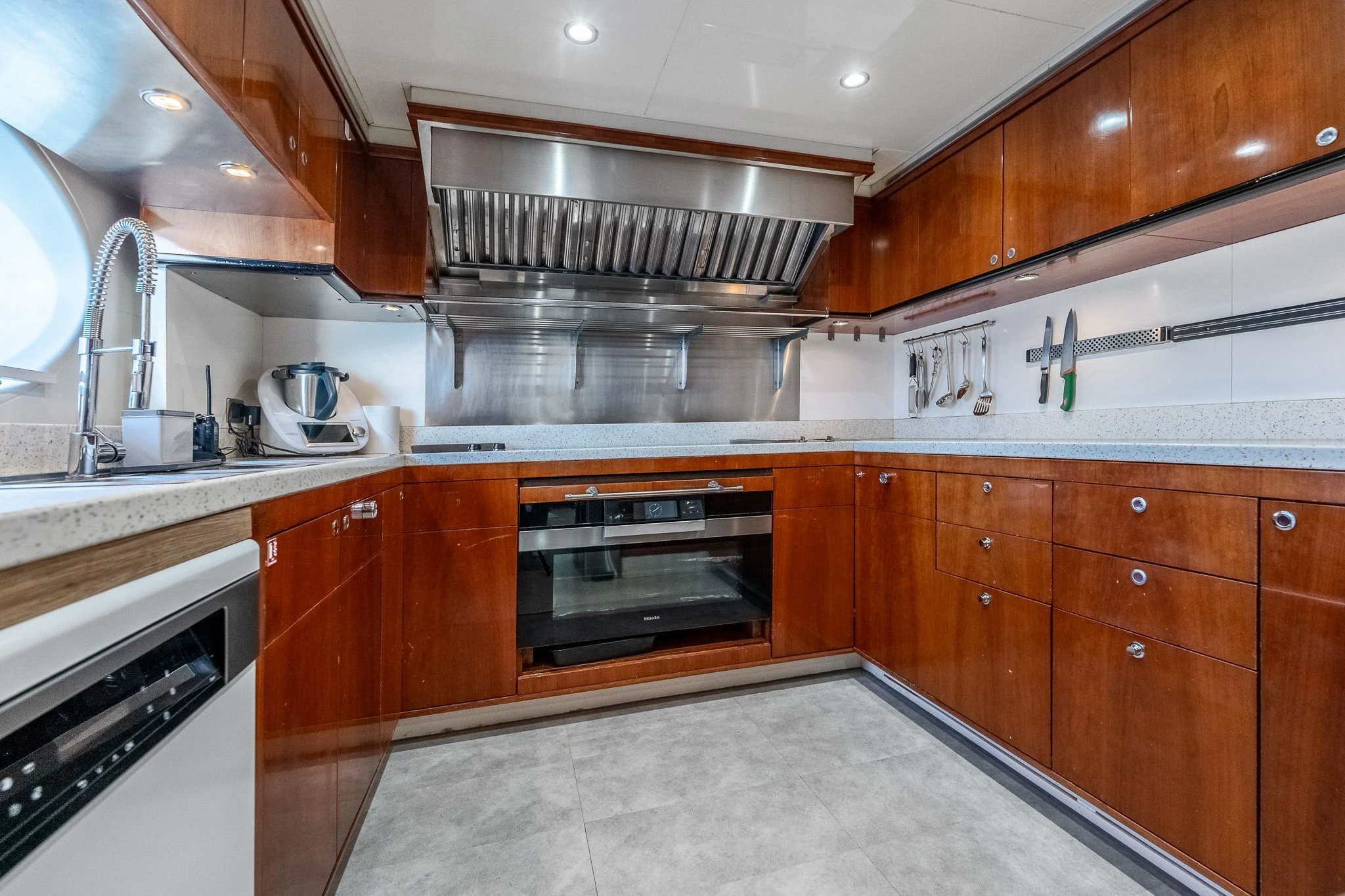 a kitchen with wooden cabinets aboard GRAND CRU Yacht for Sale