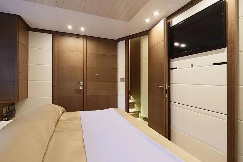a hotel room with a bed and tv aboard TOP SHELF Yacht for Sale