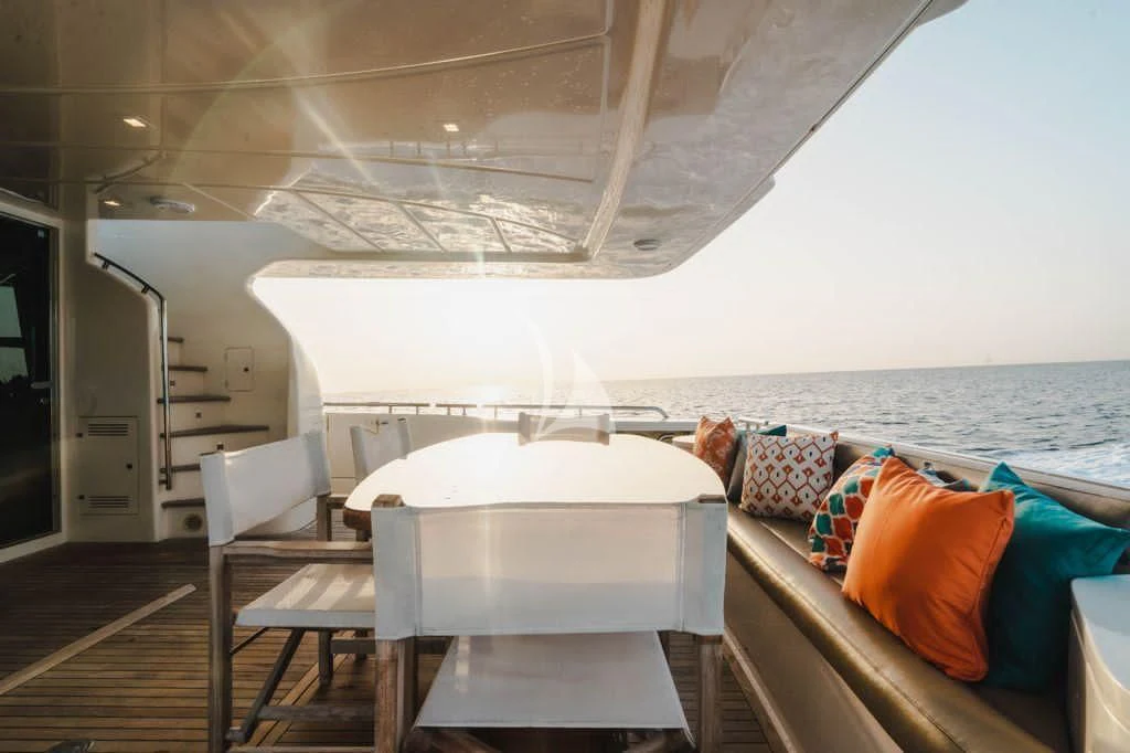 a boat with a table and chairs on a deck aboard TOP SHELF Yacht for Sale