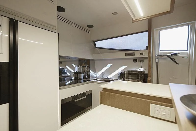 a kitchen with a large window aboard TOP SHELF Yacht for Sale