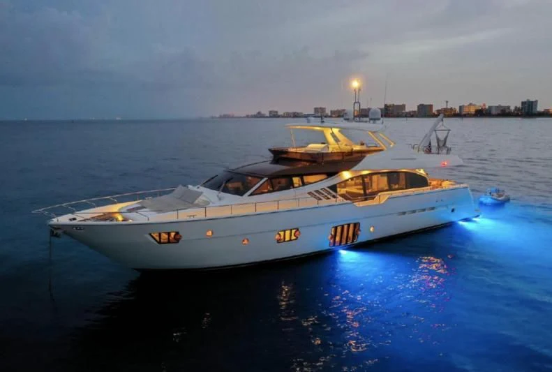 a white boat on the water aboard TOP SHELF Yacht for Sale