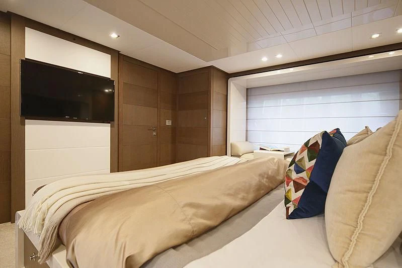 a bedroom with a bed and a television aboard TOP SHELF Yacht for Sale