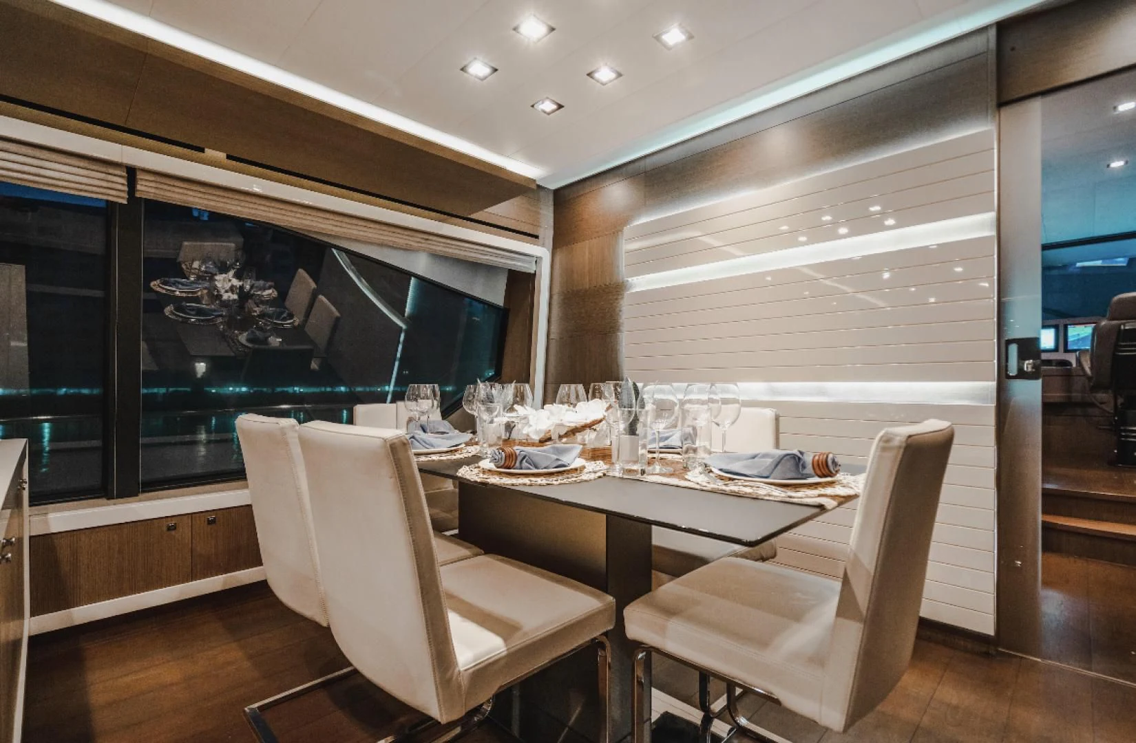 a room with a table chairs and a large window aboard TOP SHELF Yacht for Sale
