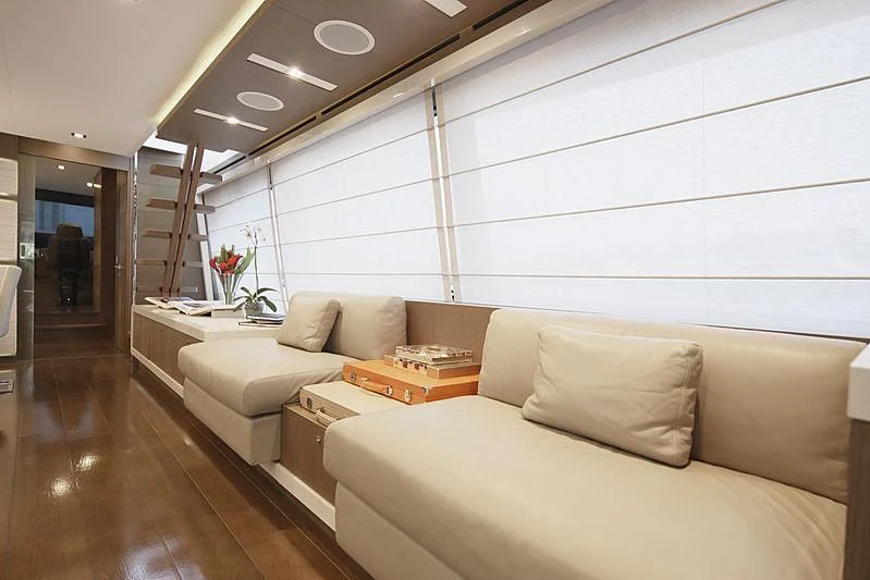 a room with couches and a table aboard TOP SHELF Yacht for Sale