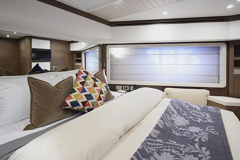 a room with a bed and a window aboard TOP SHELF Yacht for Sale