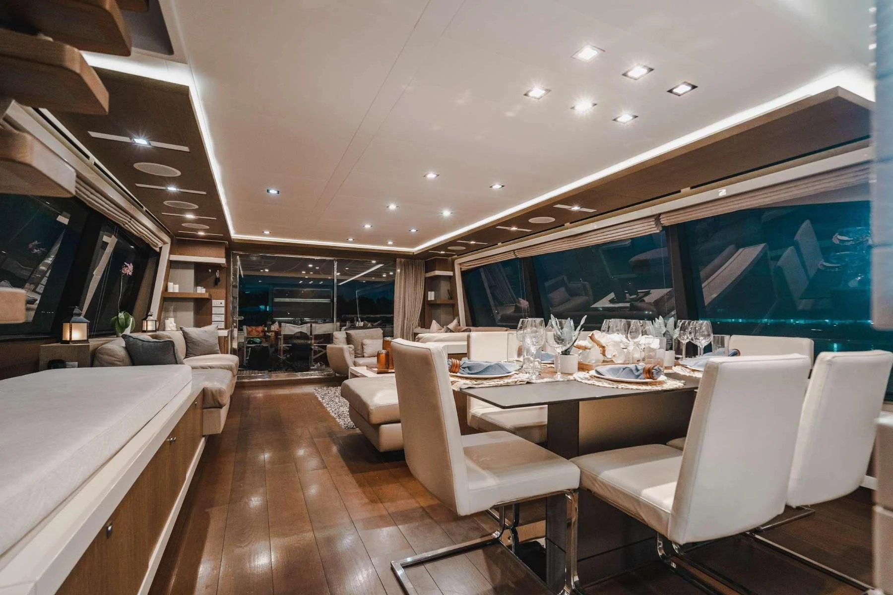 a room with a table chairs and a large window aboard TOP SHELF Yacht for Sale