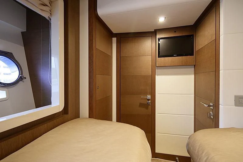 a bedroom with a bed and a closet aboard TOP SHELF Yacht for Sale