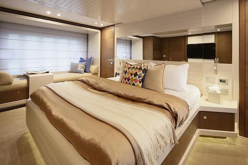 a room with a bed and a couch aboard TOP SHELF Yacht for Sale