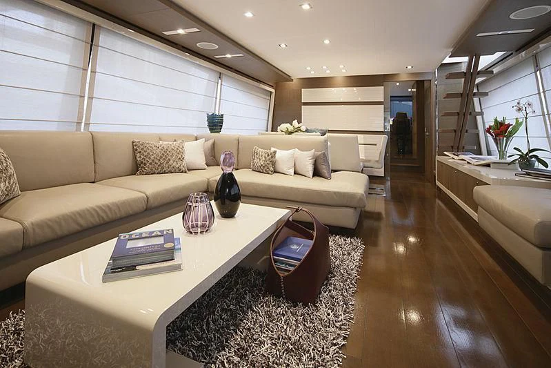 a living room with a couch and a coffee table aboard TOP SHELF Yacht for Sale