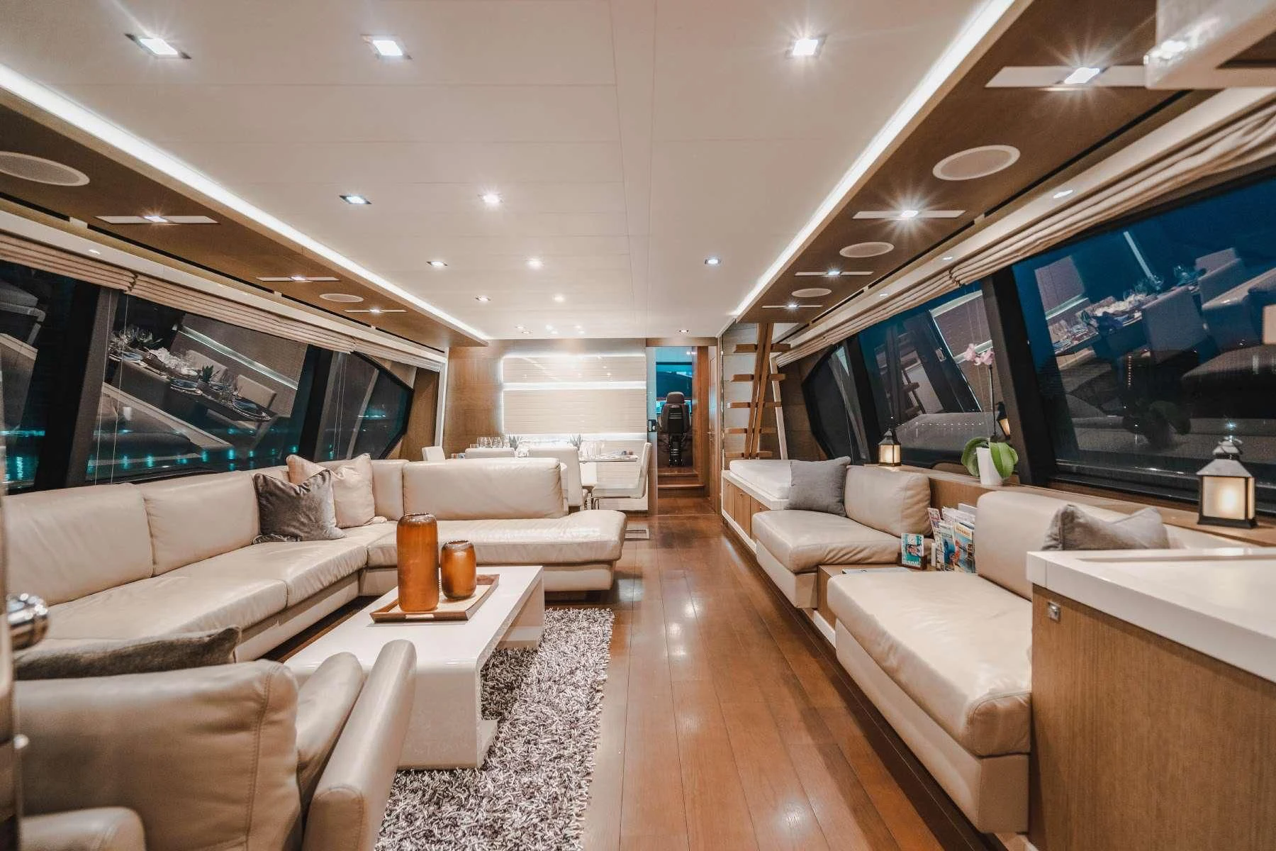 a living room with a large screen aboard TOP SHELF Yacht for Sale