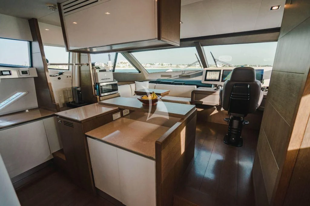 a room with a table and chairs aboard TOP SHELF Yacht for Sale