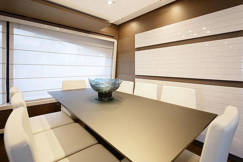 a table with chairs and a bowl on it aboard TOP SHELF Yacht for Sale