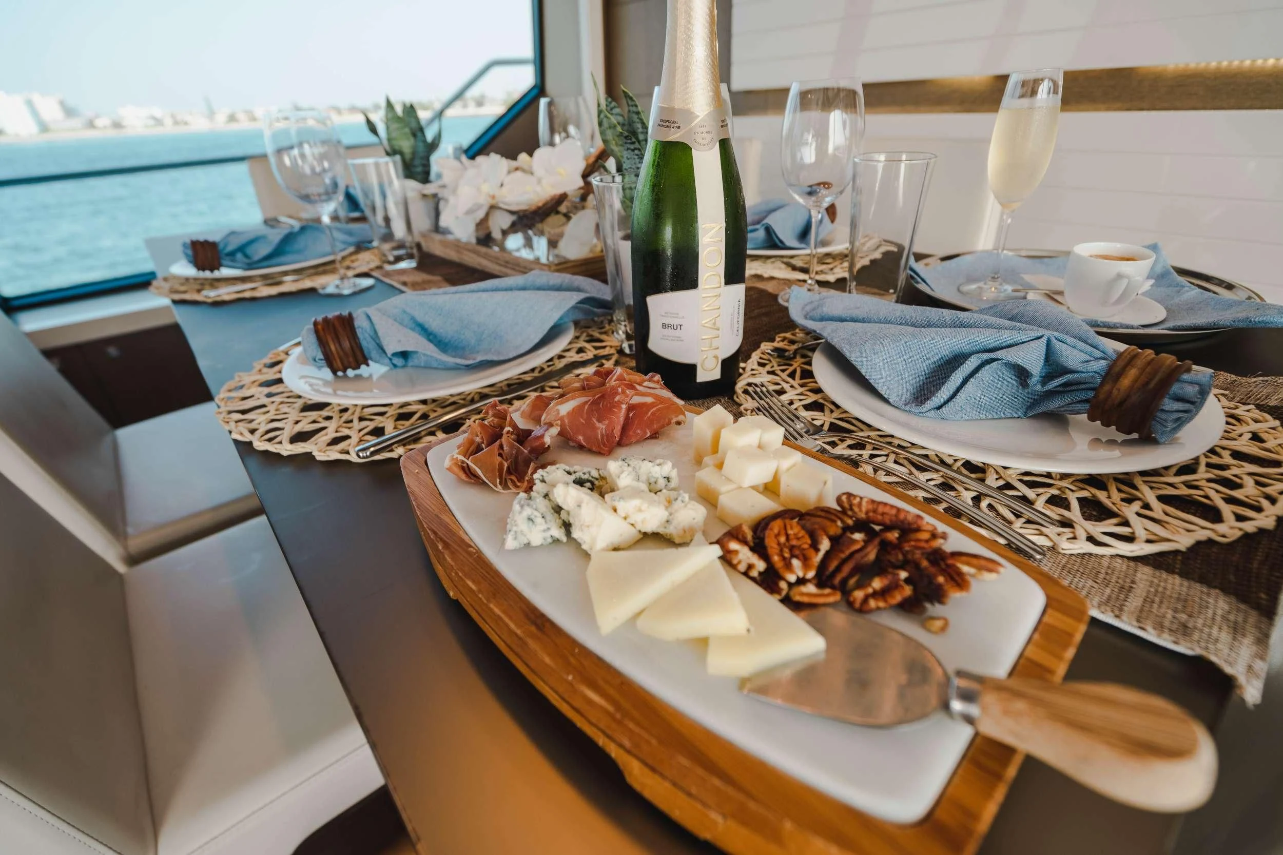 a table with food and wine aboard TOP SHELF Yacht for Sale