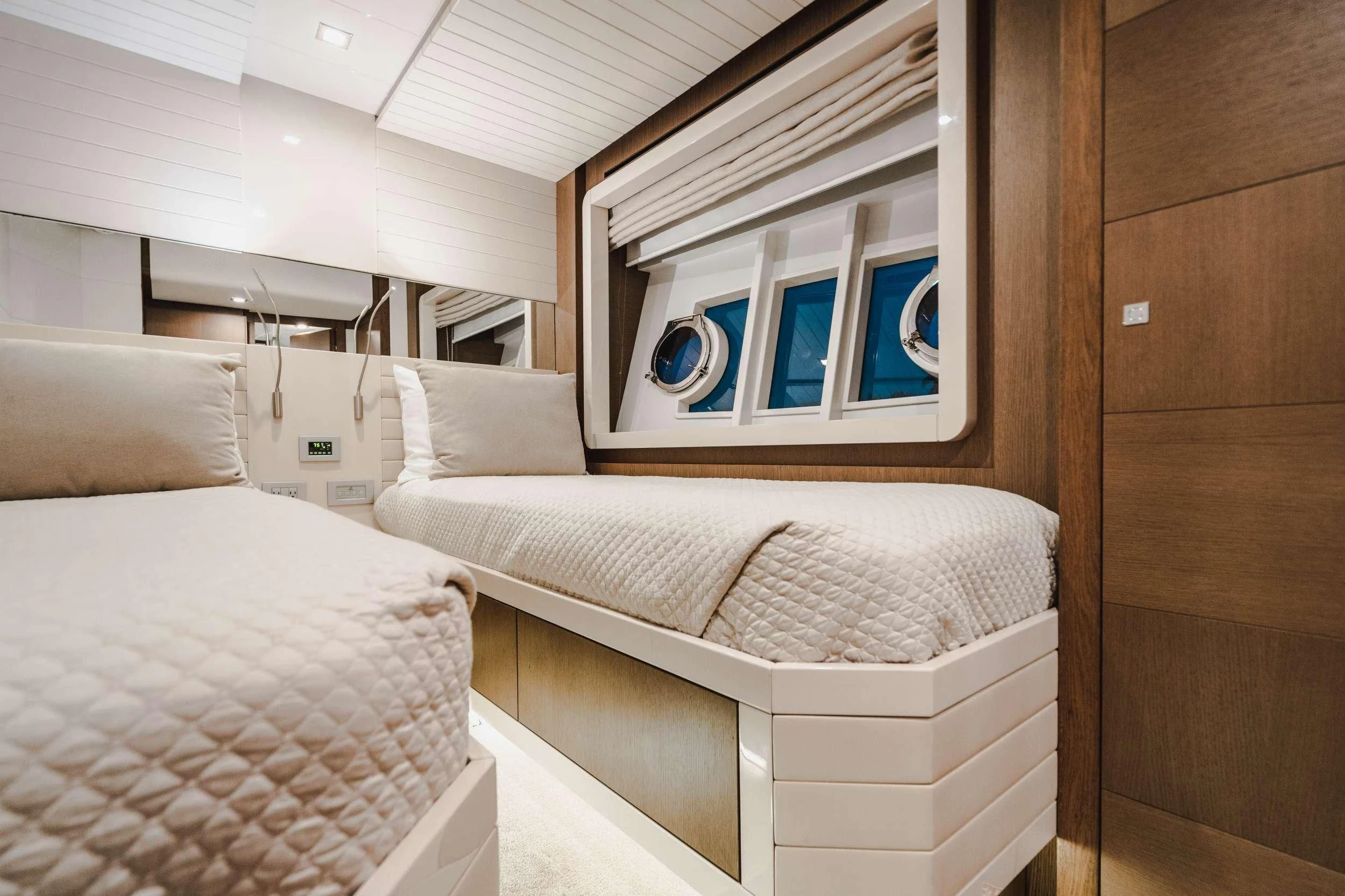 a room with two beds aboard TOP SHELF Yacht for Sale