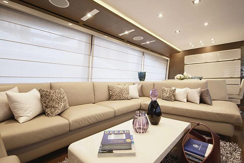 a living room with a couch and a table aboard TOP SHELF Yacht for Sale
