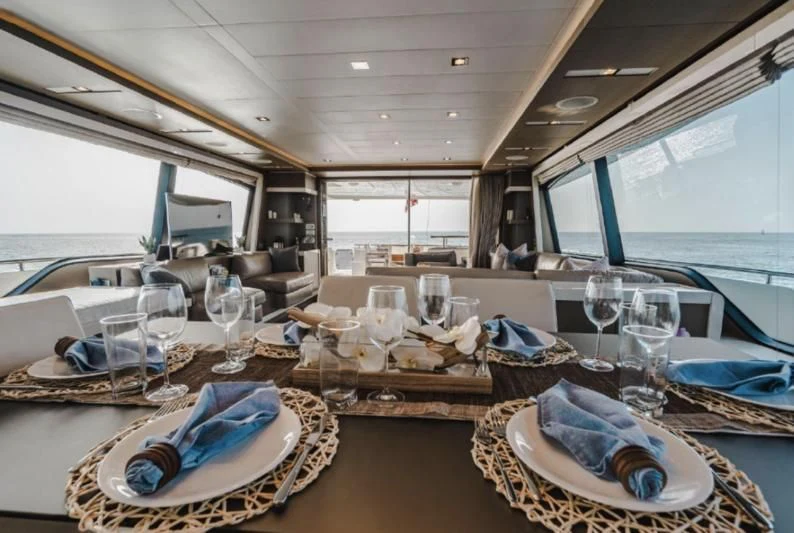 a large dining room with a large table and chairs aboard TOP SHELF Yacht for Sale