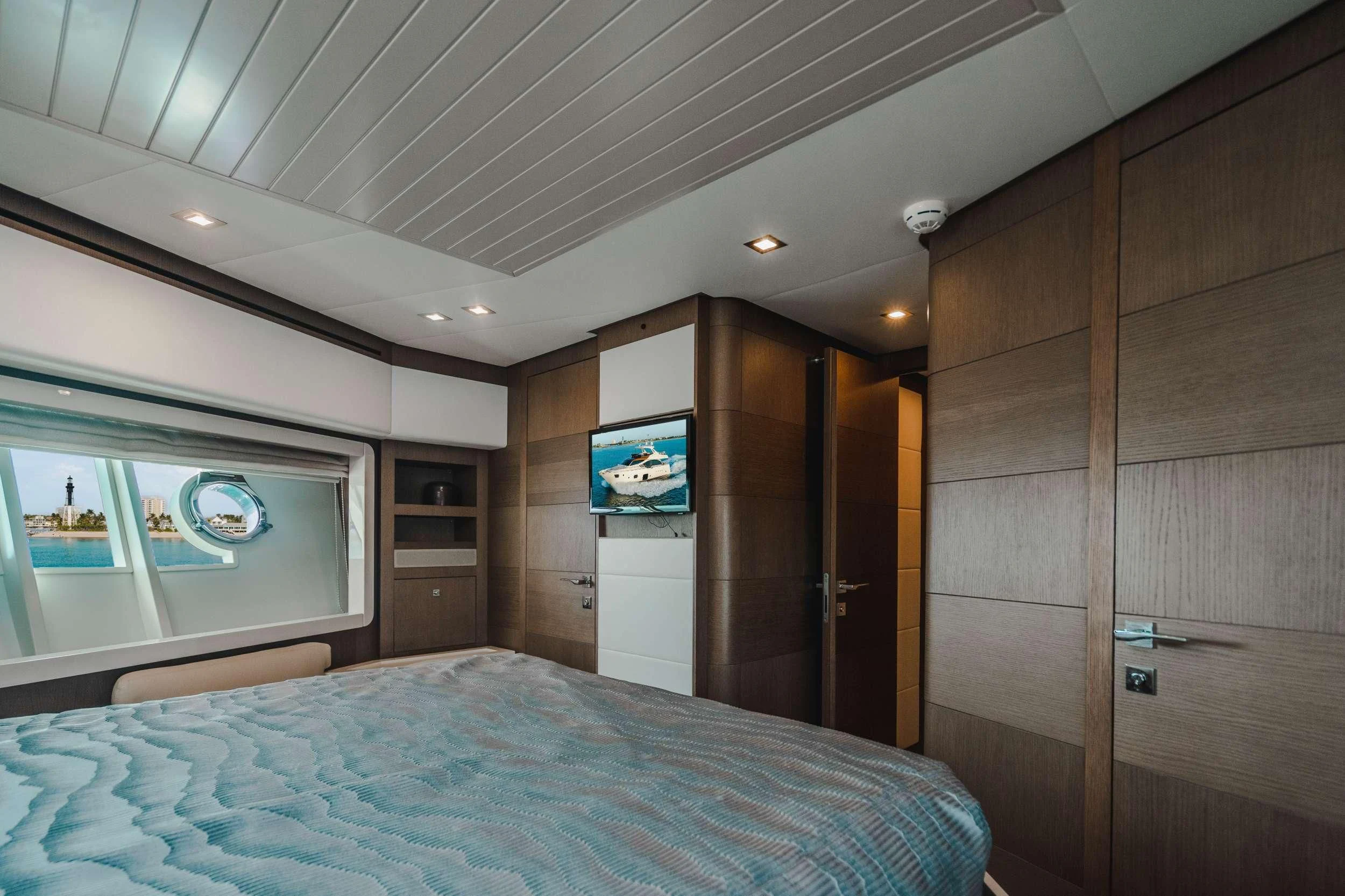 a bedroom with a bed and a television aboard TOP SHELF Yacht for Sale