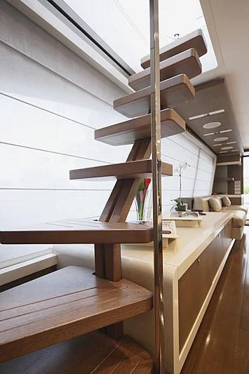a wooden staircase with a wood railing aboard TOP SHELF Yacht for Sale