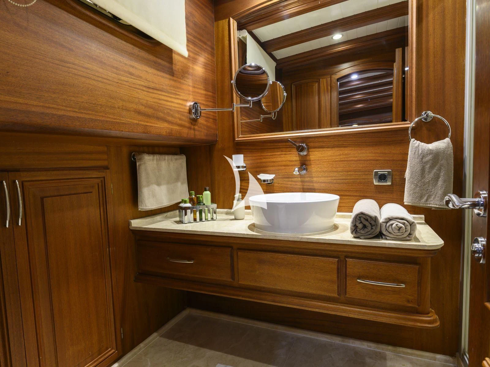 a bathroom with a sink and mirror aboard CANER IV Yacht for Sale