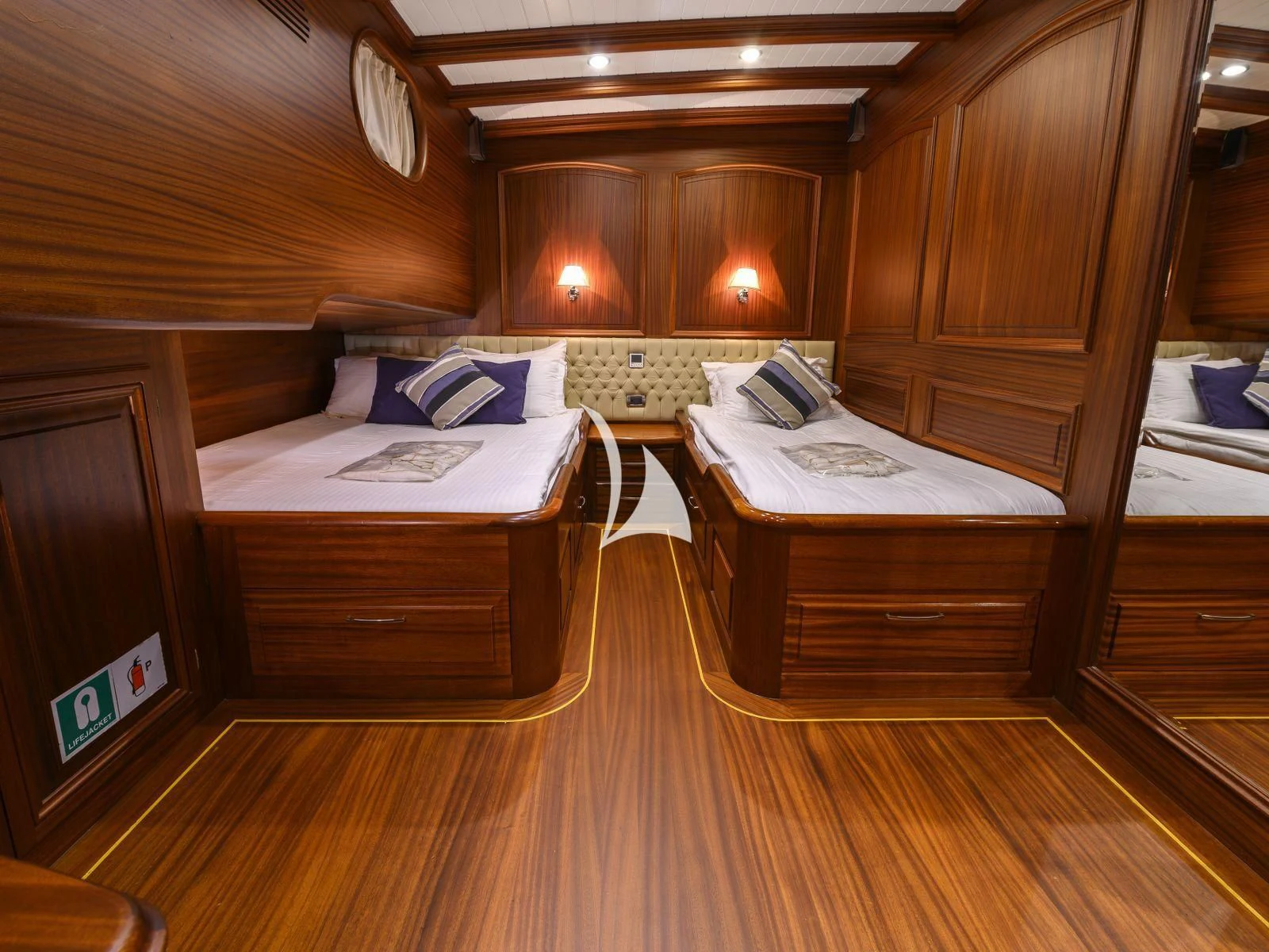a room with wooden furniture aboard CANER IV Yacht for Sale