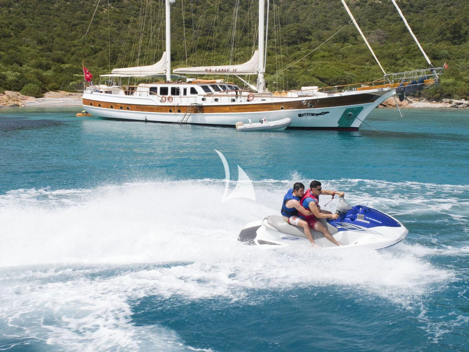 a group of people on a jet ski in the water aboard CANER IV Yacht for Sale