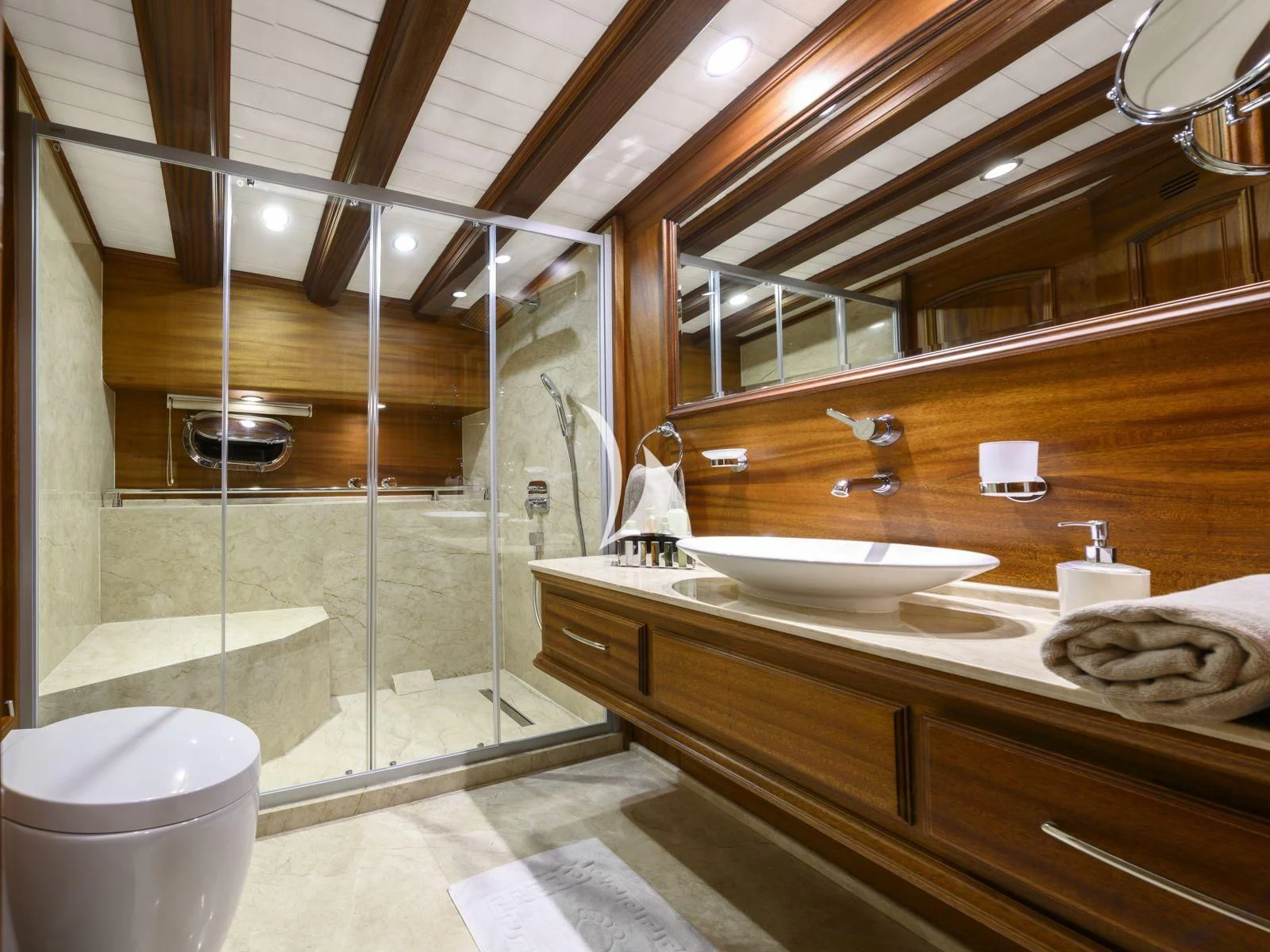 a bathroom with a glass shower aboard CANER IV Yacht for Sale