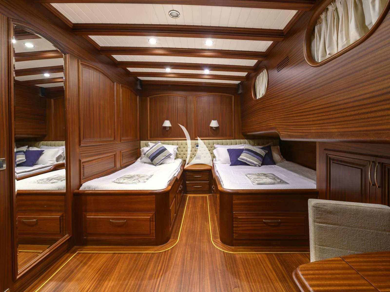 a room with wooden furniture aboard CANER IV Yacht for Sale