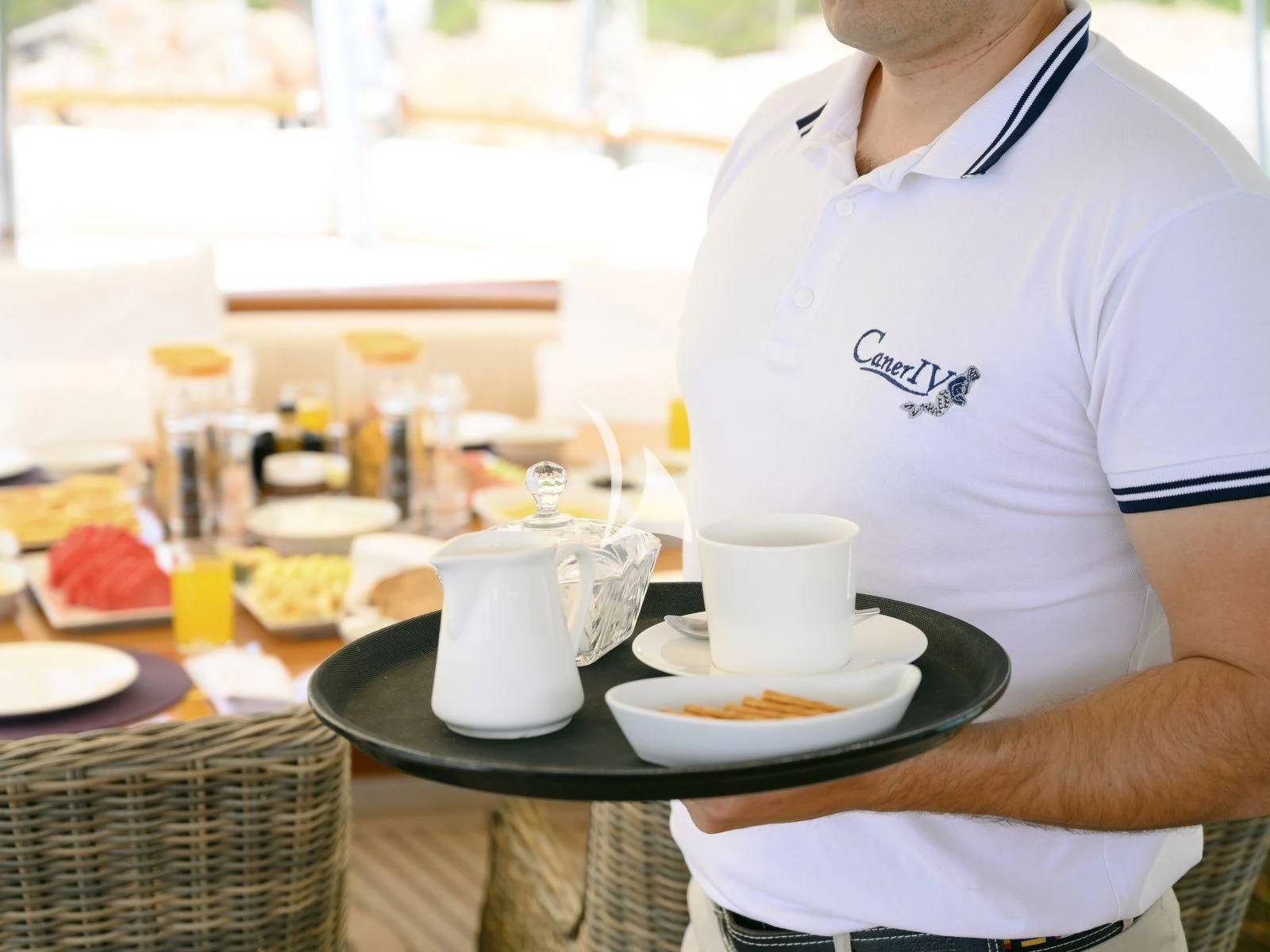 a man in a white shirt aboard CANER IV Yacht for Sale