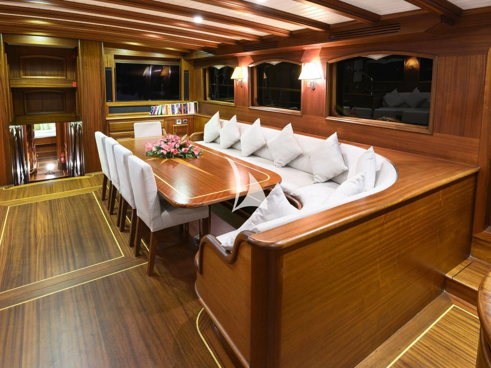 a room with a table and couch aboard CANER IV Yacht for Sale