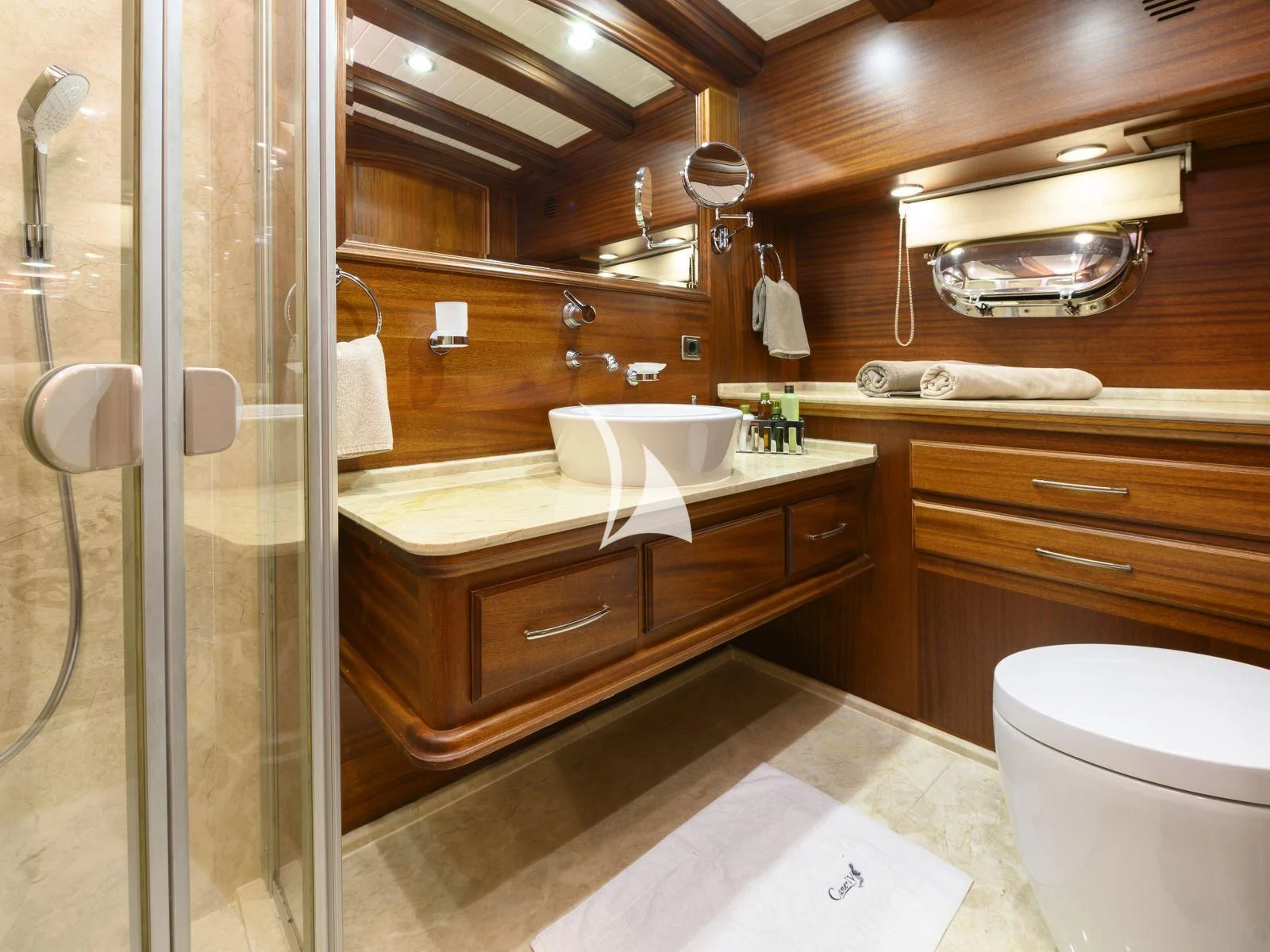 a bathroom with a glass shower aboard CANER IV Yacht for Sale